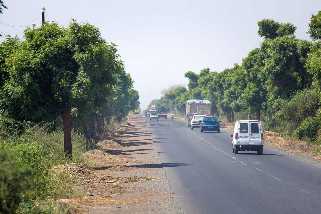 The N2 trunk road in Senegal, traffic between two villages.