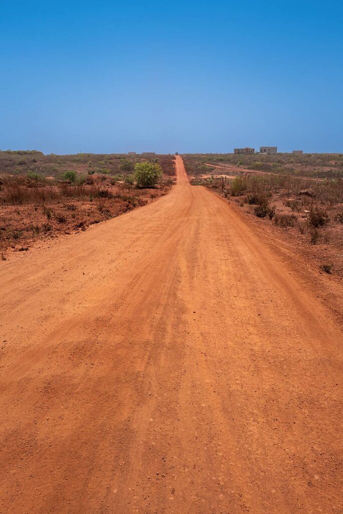 A red laterite track in Senegal, where the tarmac ends.